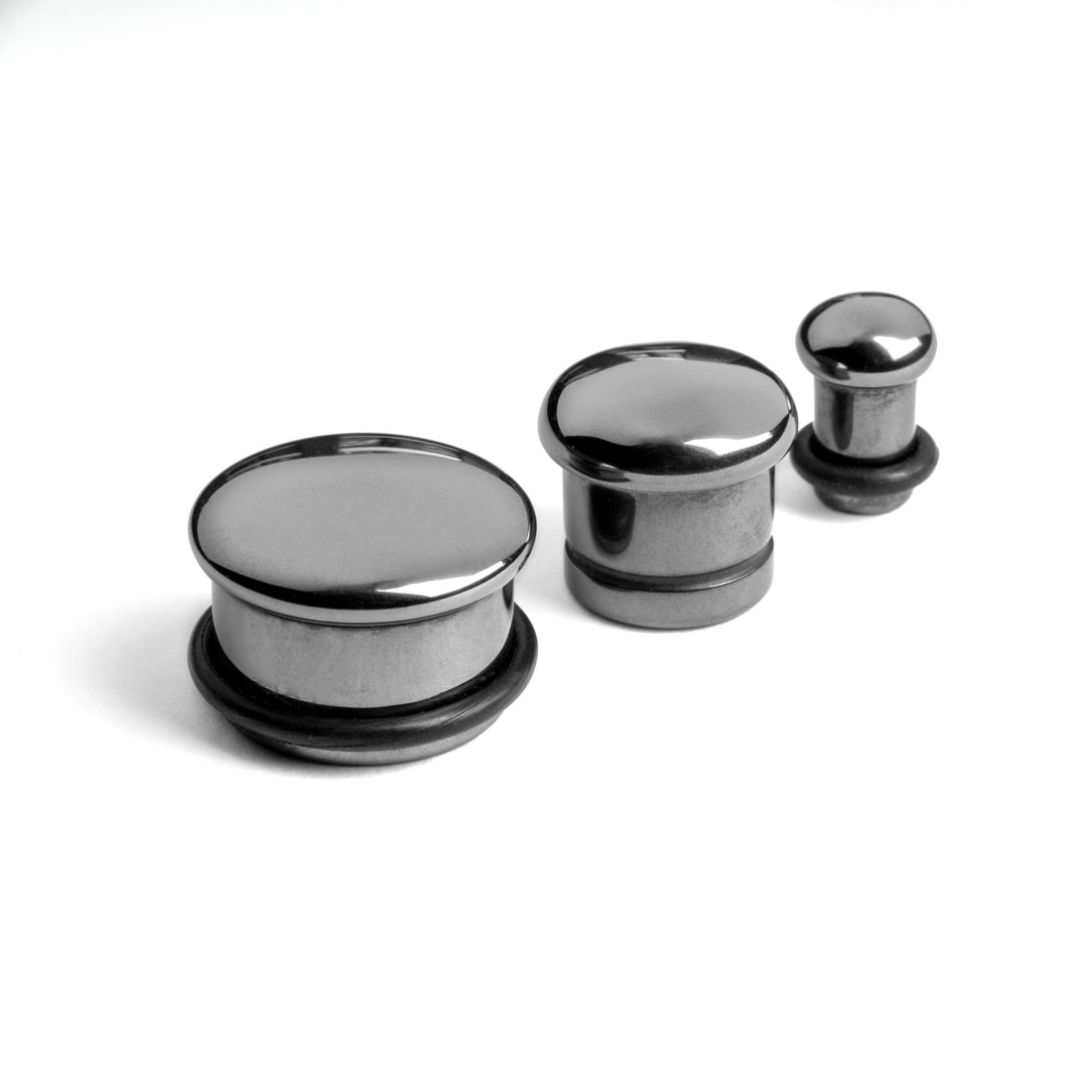 several sizes of Single Flared Hematite Stone Plugs front side view