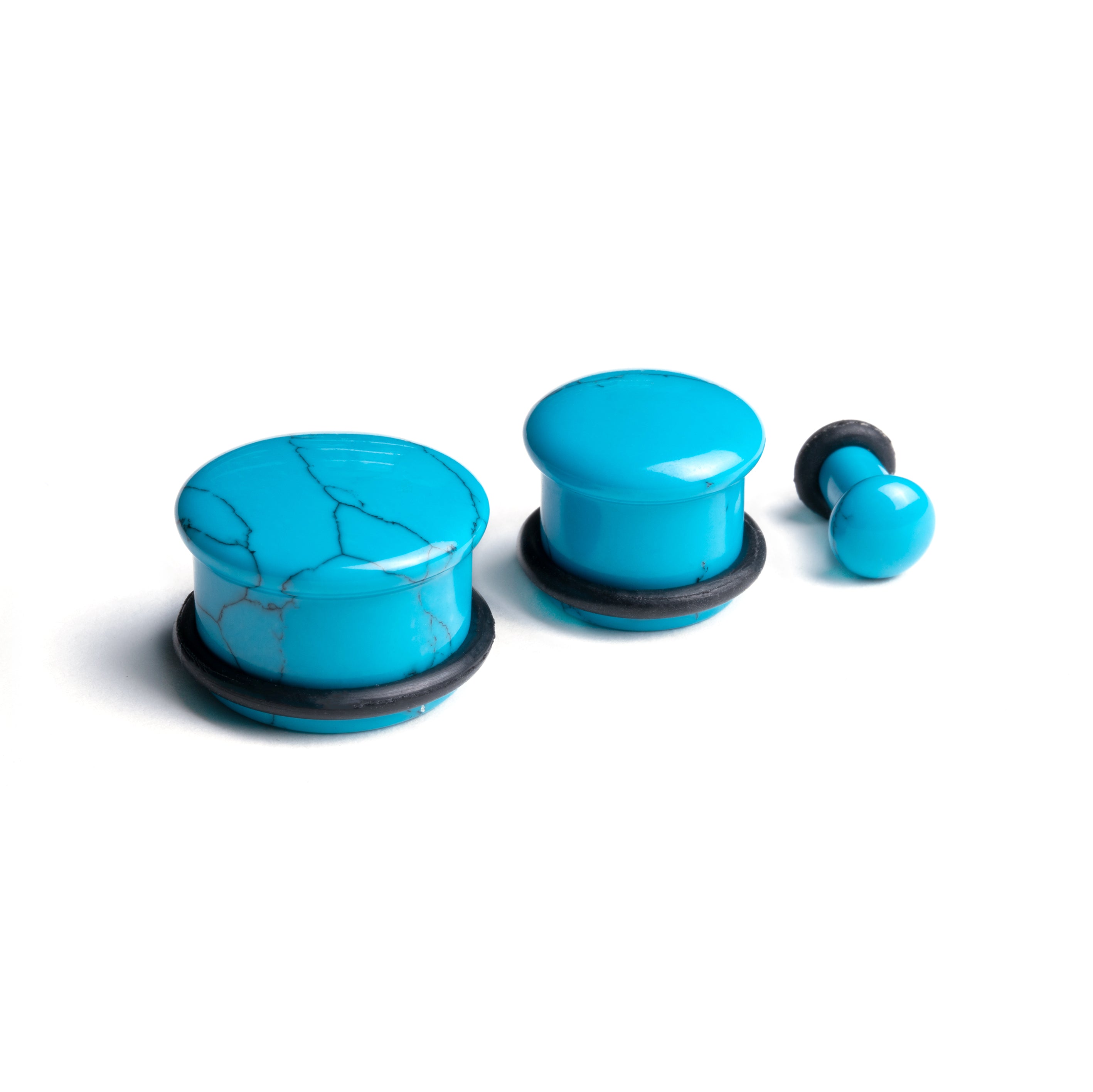 several sizes of flared Turquoise stone ear plugs side view