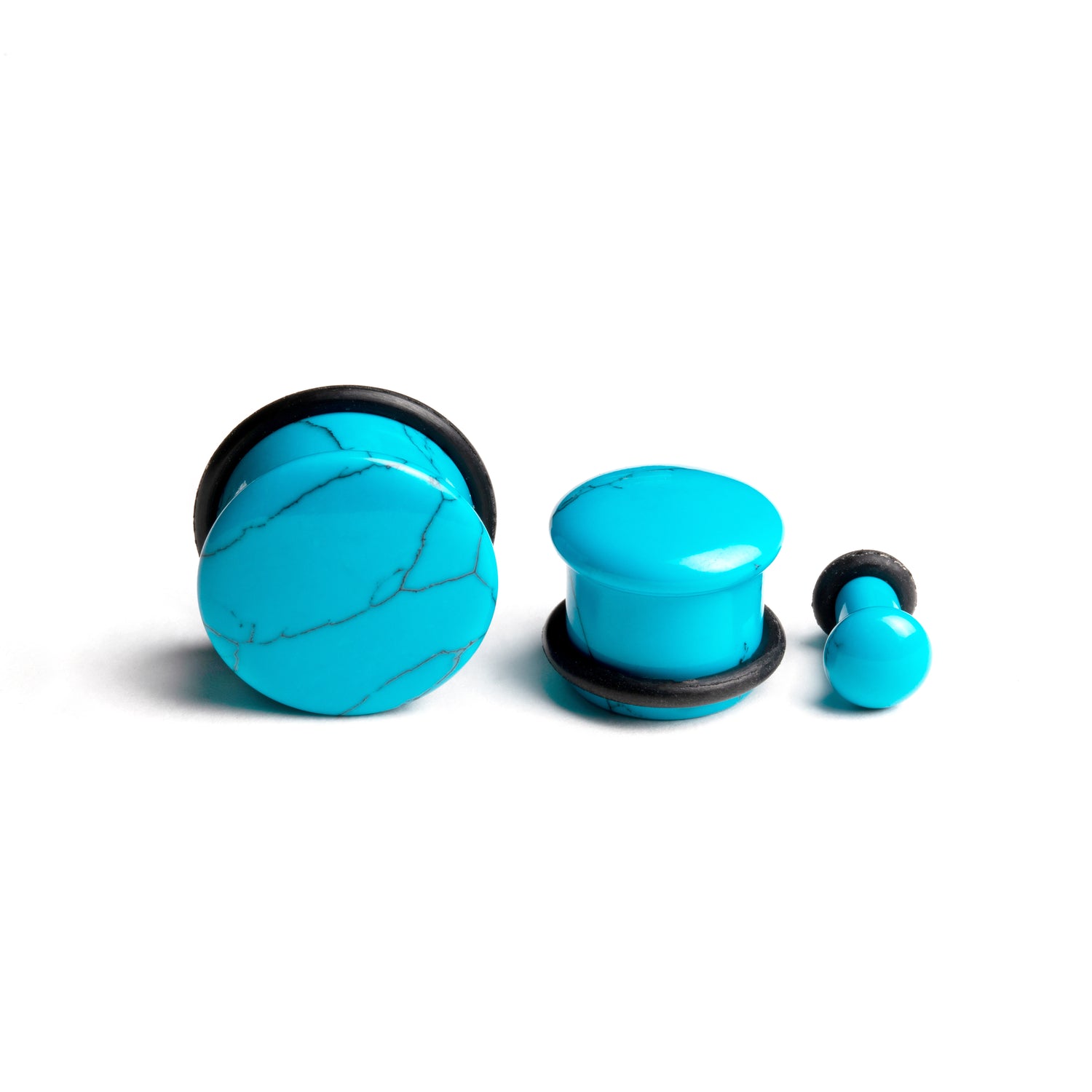 several sizes of flared Turquoise stone ear plugs side and front view