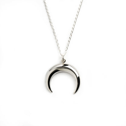 Silver crescent moon charm on a chain necklace frontal view