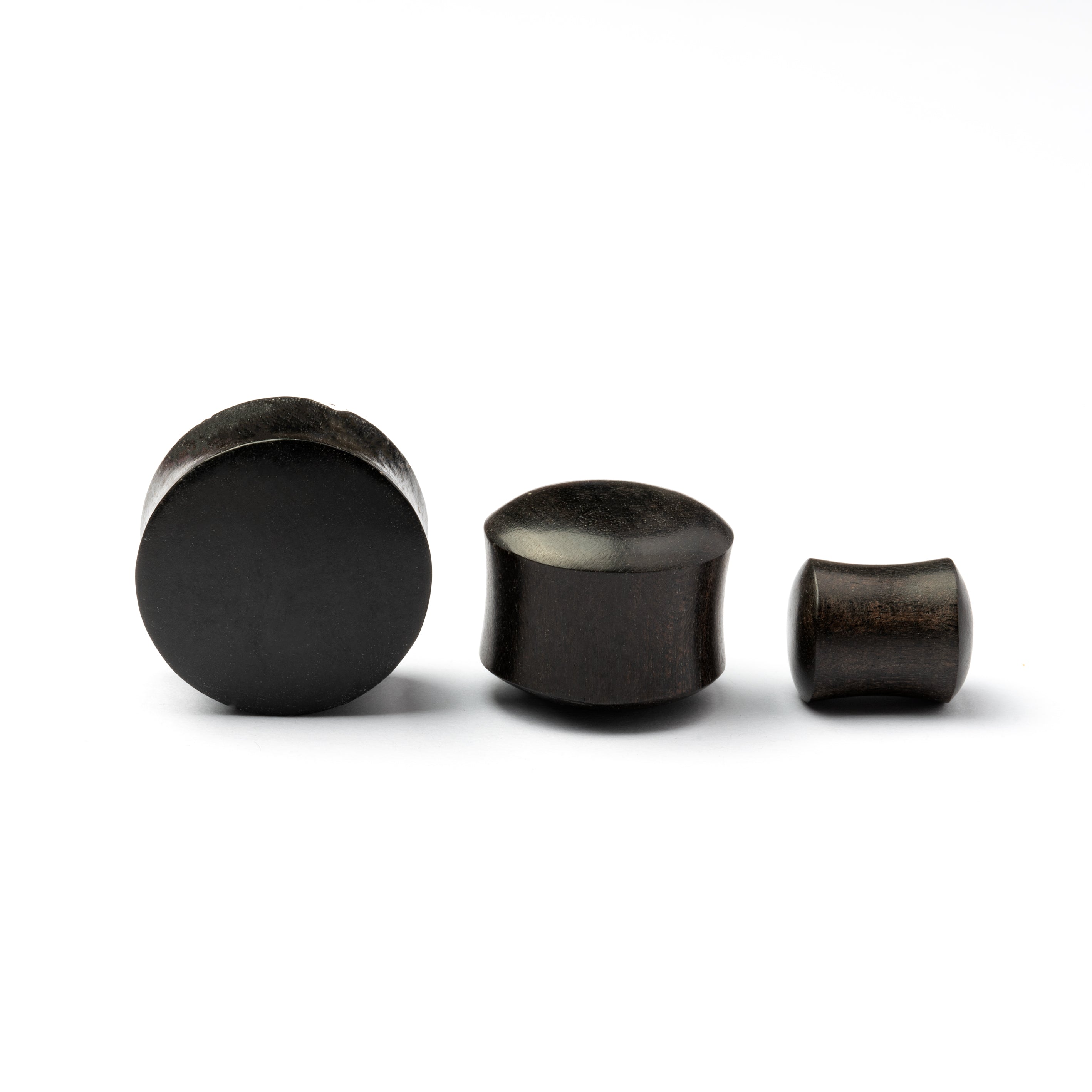 Several sizes of smooth black wood plugs front and side view