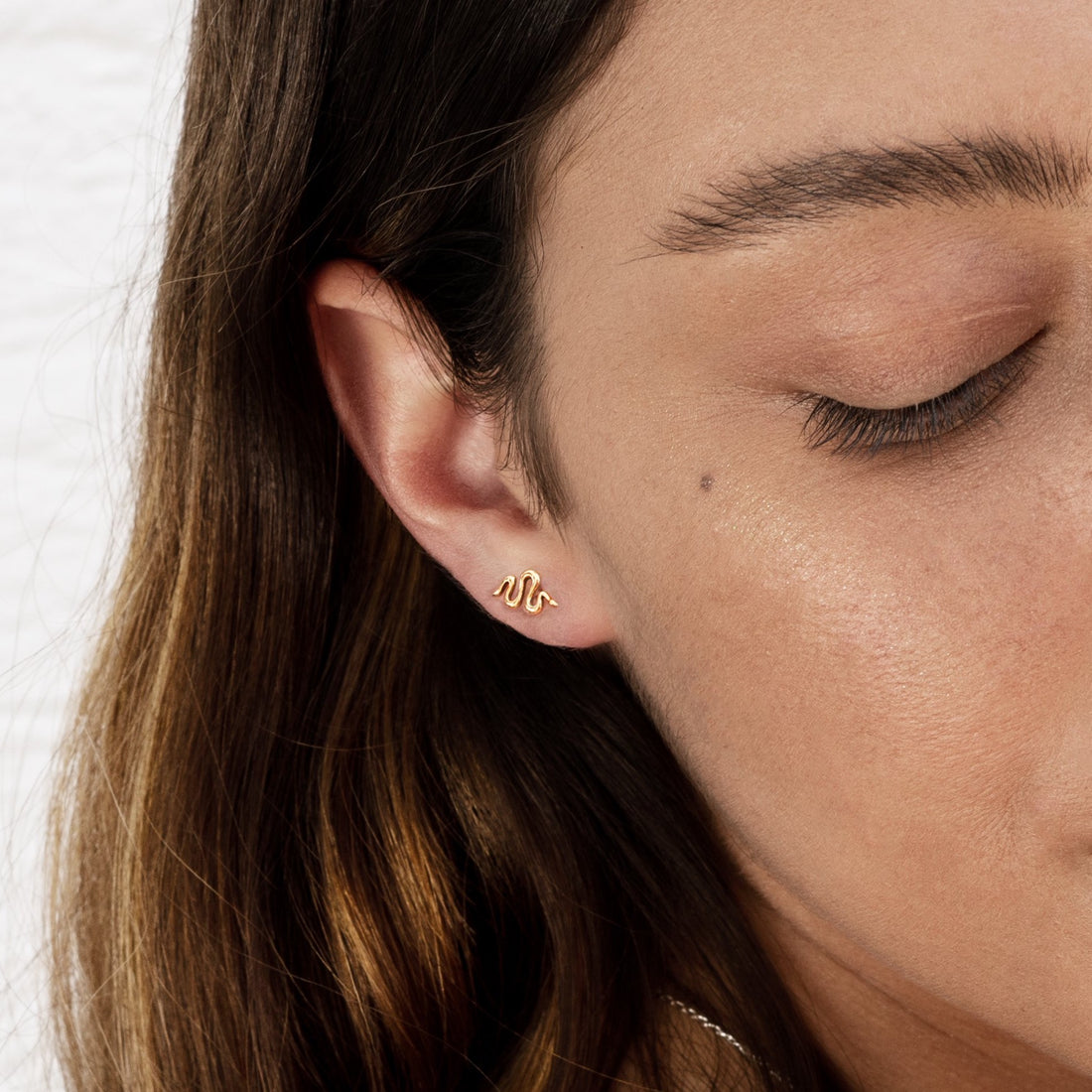 model wearing Snake bronze studs