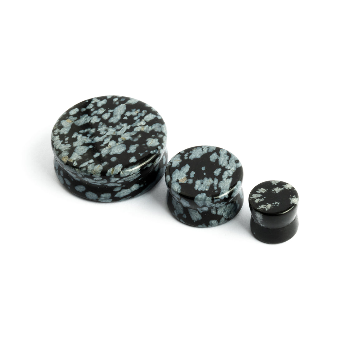 several sizes of double flare Snowflake Obsidian stone ear plugs  front side view