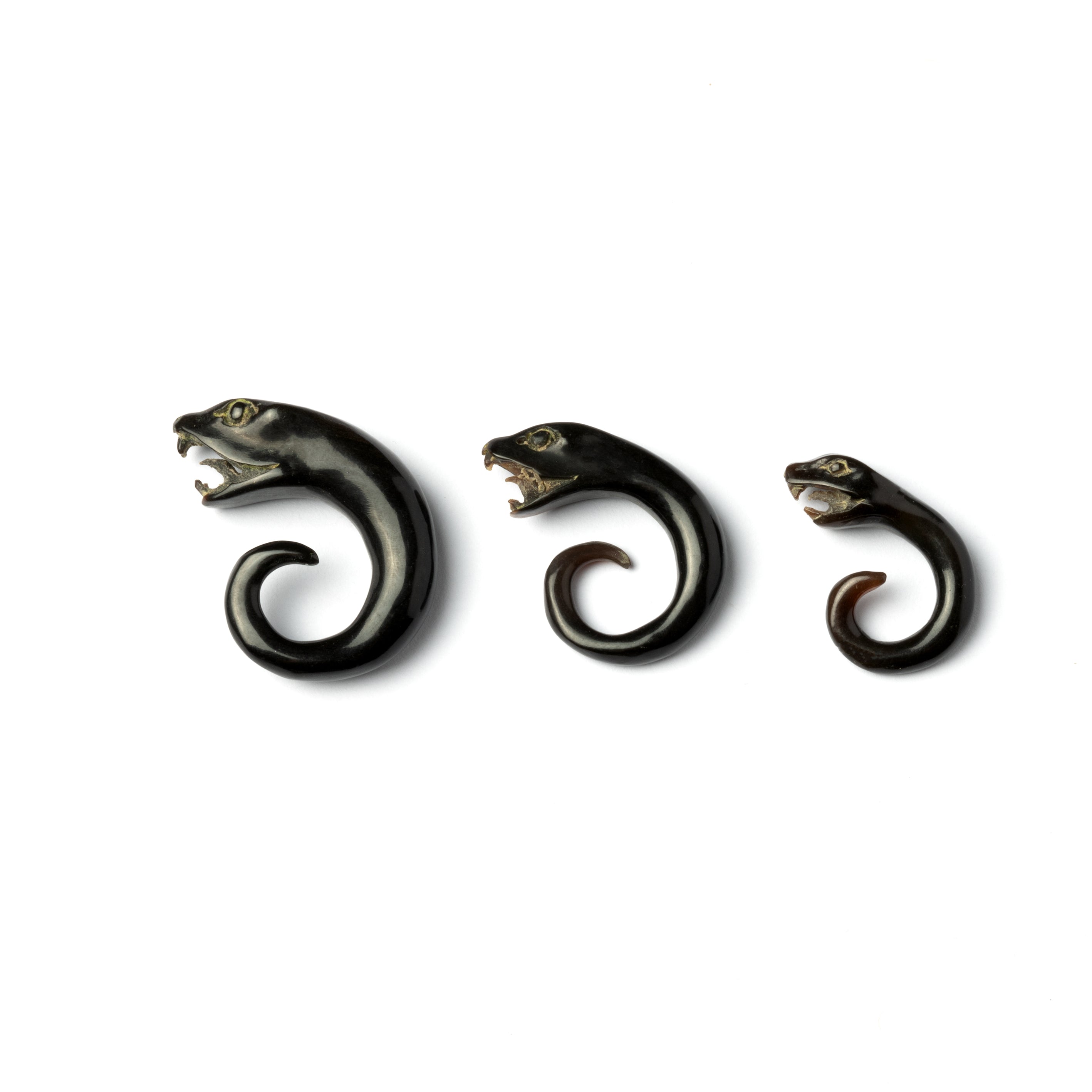 SEVERAL SIZES OF HORN CARVED SNAKE HEAD EAR STRETCHERS SIDE VIEW