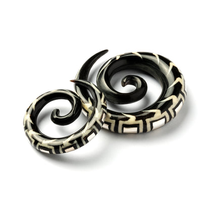 two spiral horn ear stretchers with geometric shaped inlaid with silver side and front view