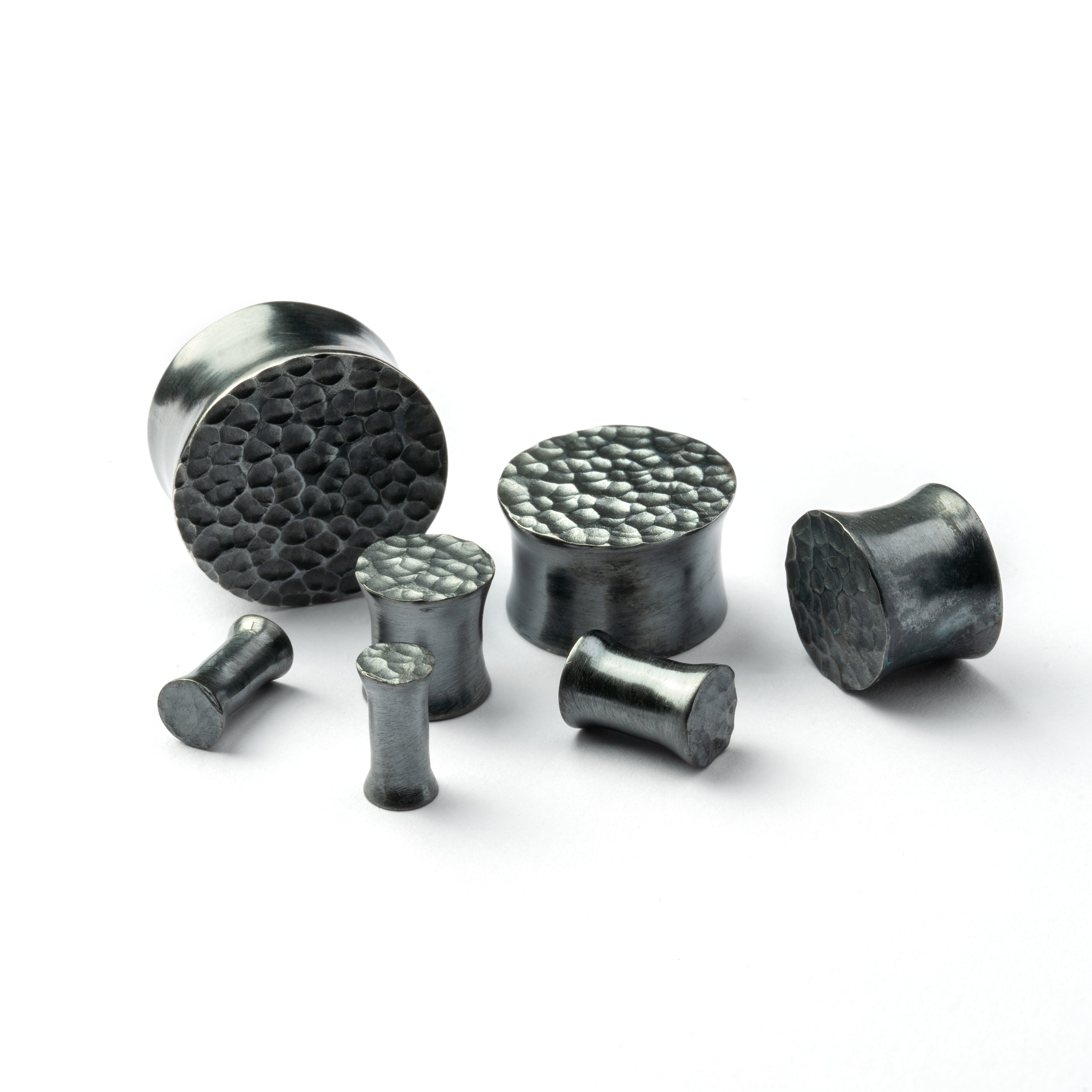 several sizes of hammered black silver double flared ear plugs all view