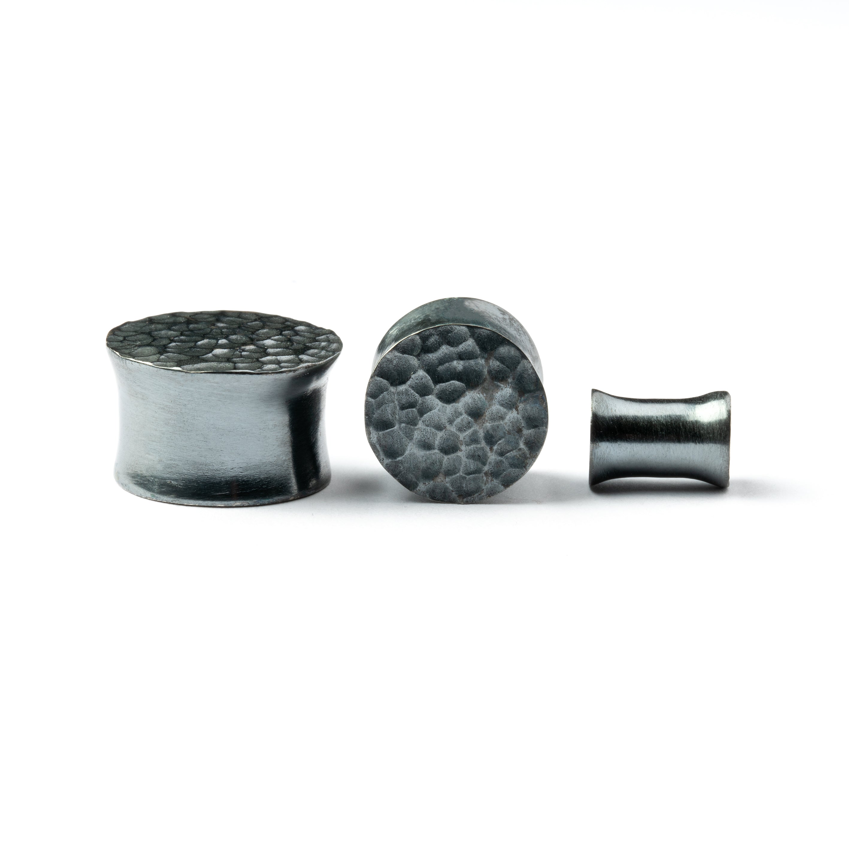 several sizes of hammered black silver double flared ear plugs front and side view