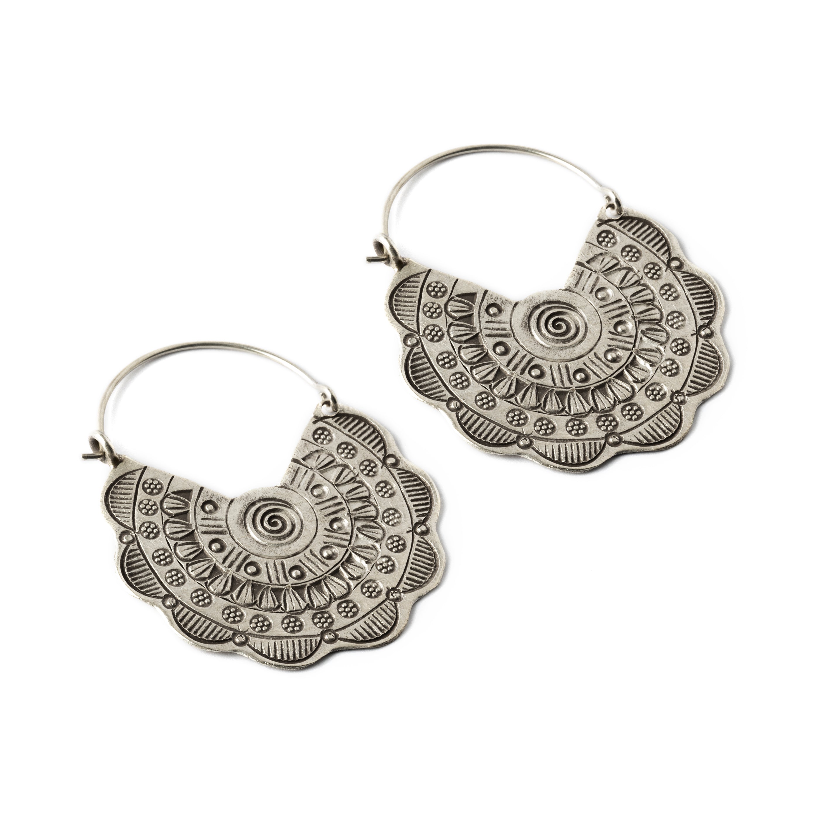 pair of flower disc silver earrings with tribal motifs stamps left side view