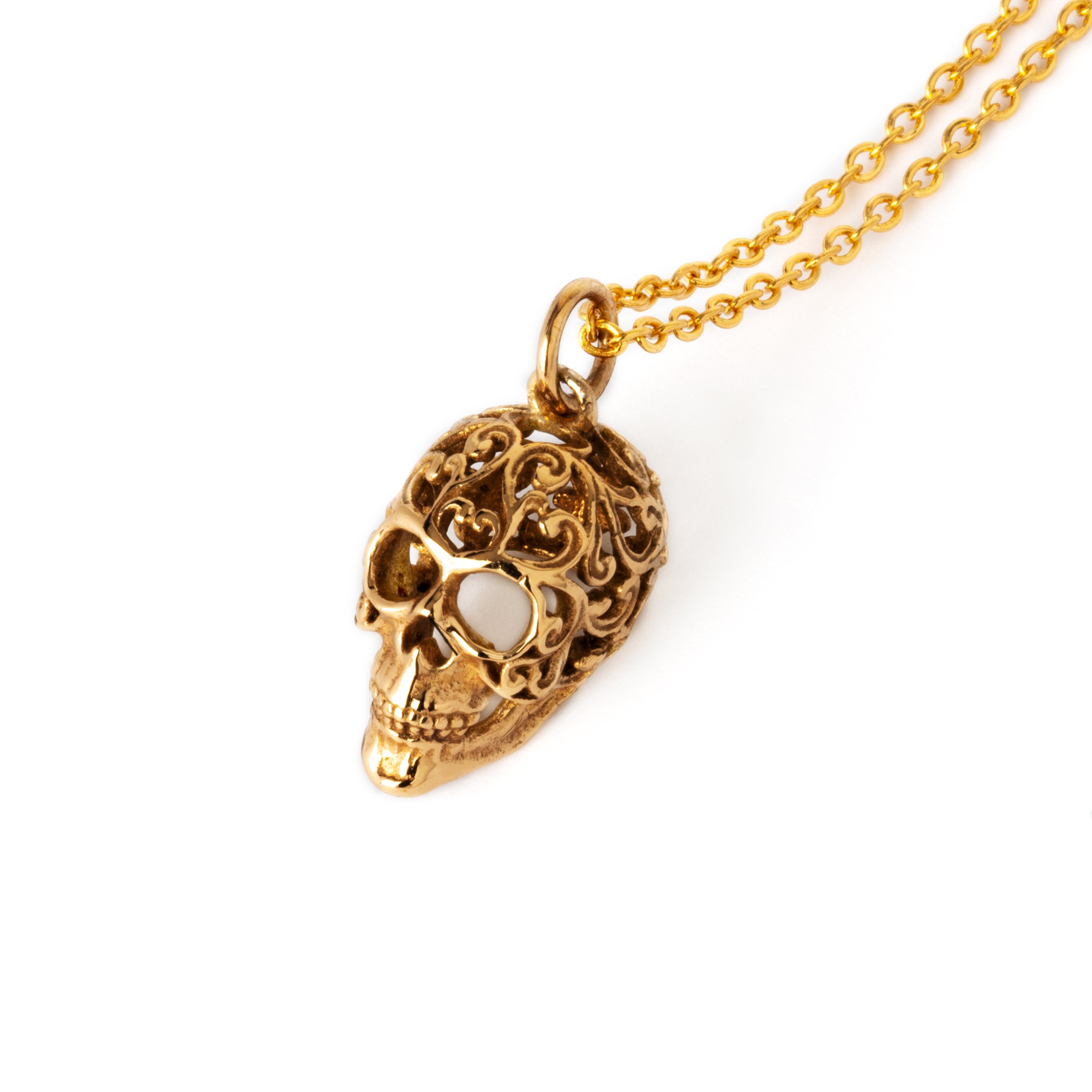 Bronze sugar skull charm on a chain above view
