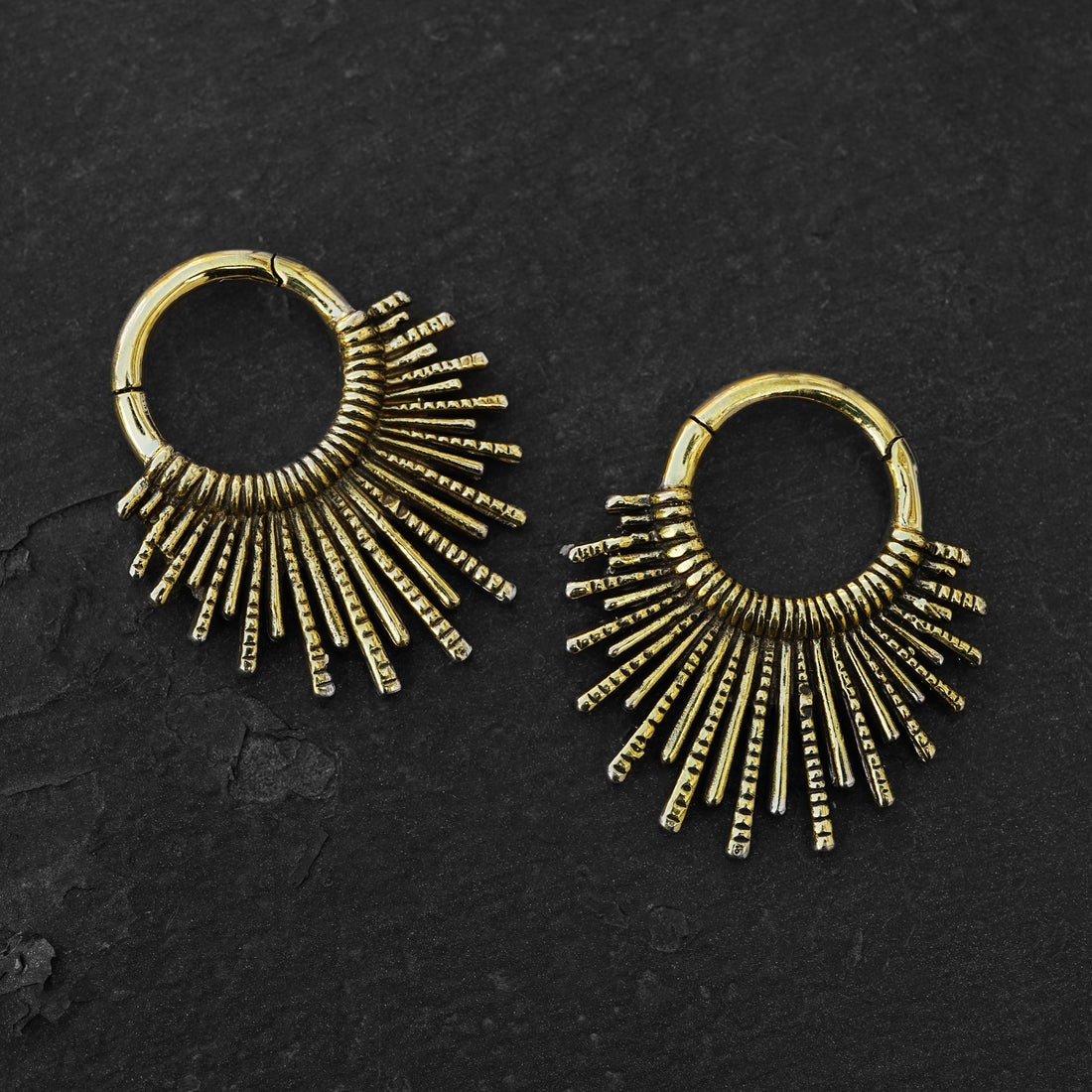 pair of gold brass tribal sun hoops hangers frontal view black background