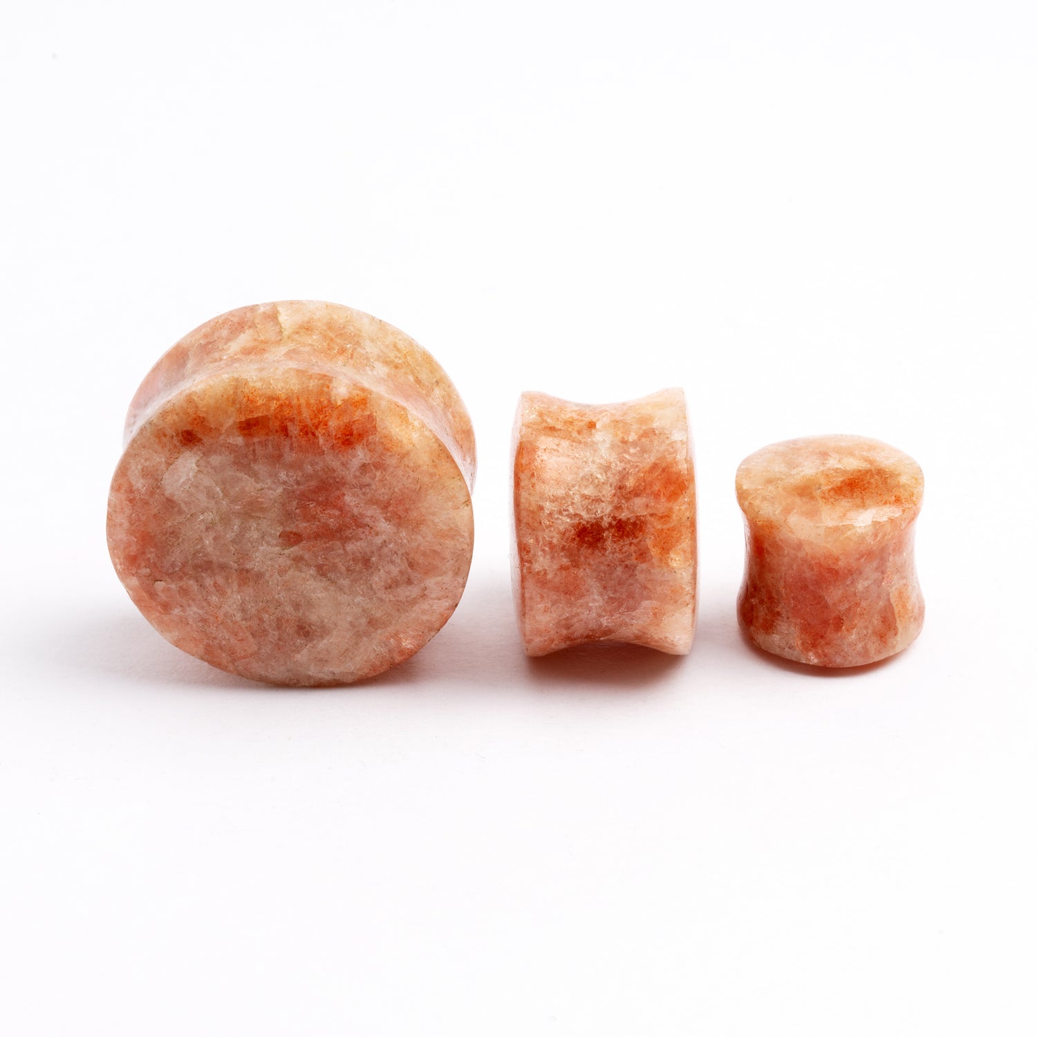 several sizes of Sunstone double flare ear plugs front and side view