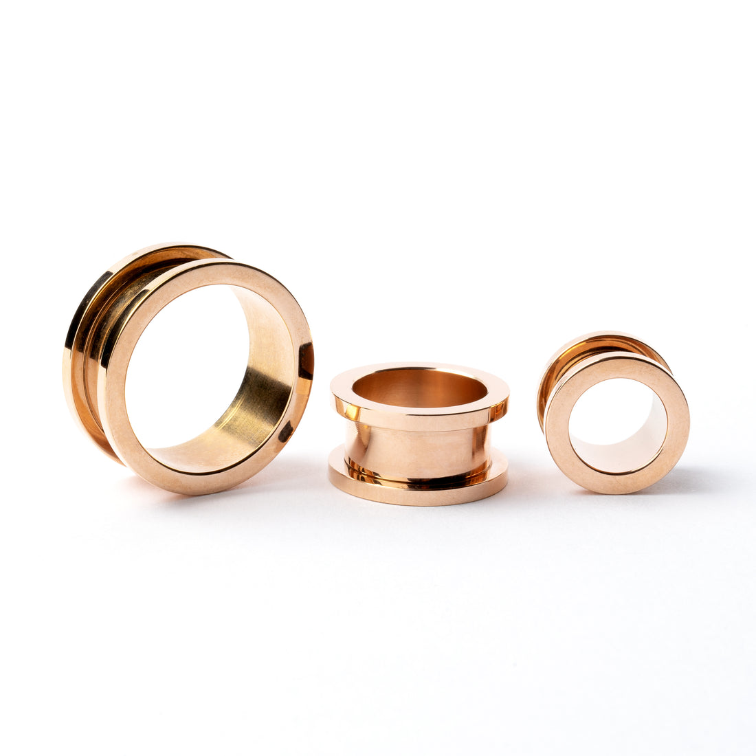 several sizes of rose gold surgical steel ear tunnel with double flared ends front and side view