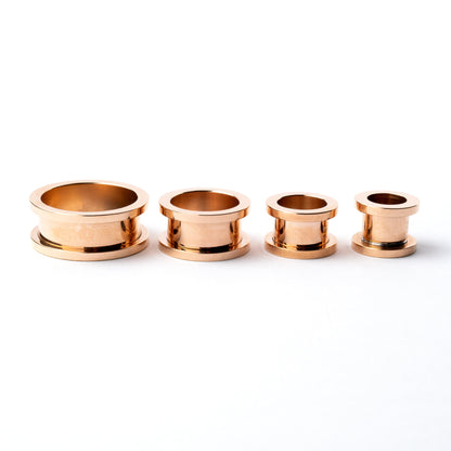 several sizes of rose gold surgical steel ear tunnel with double flared ends side view