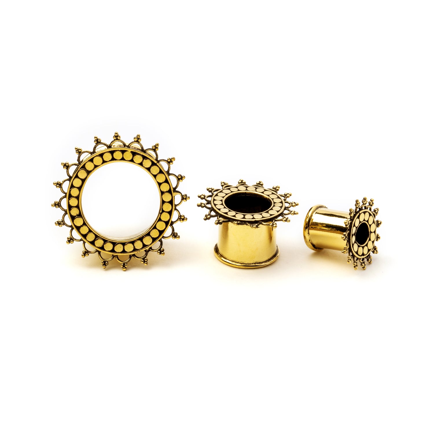 several sizes of golden brass tribal flower ear tunnels frontal and side view