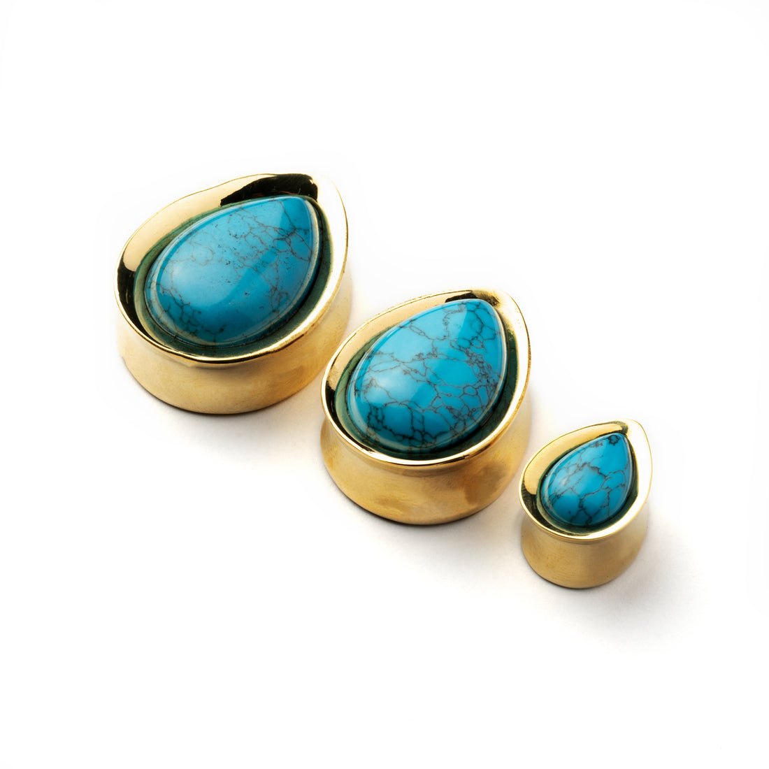 several sizes of Golden brass teardrop Turquoise ear plugs front side view