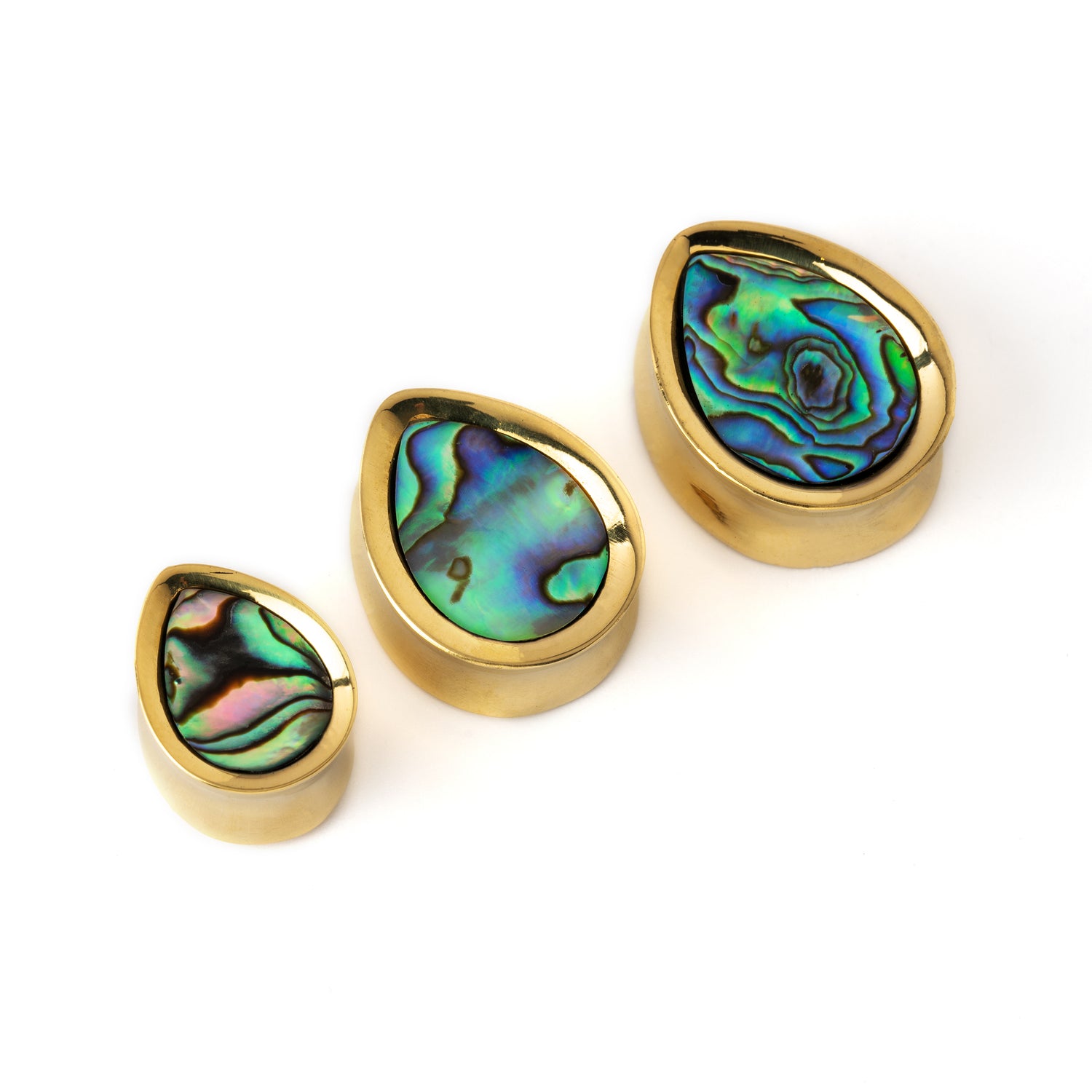 different sizes of golden teardrop shaped plug earrings with abalone shell inlay side view