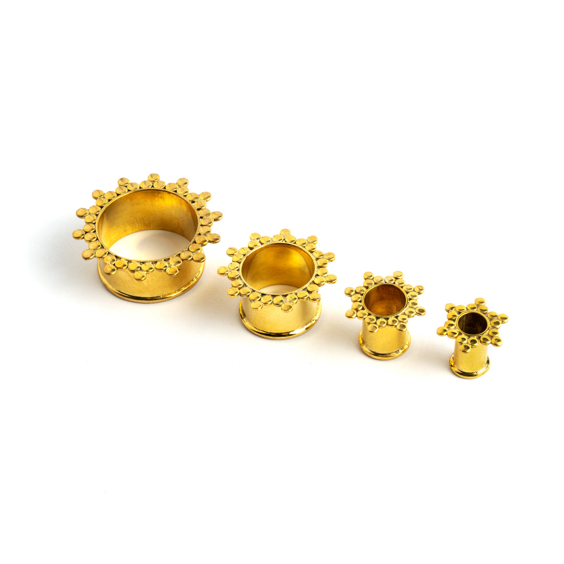several sizes of golden brass spheres flower ear tunnels front side view