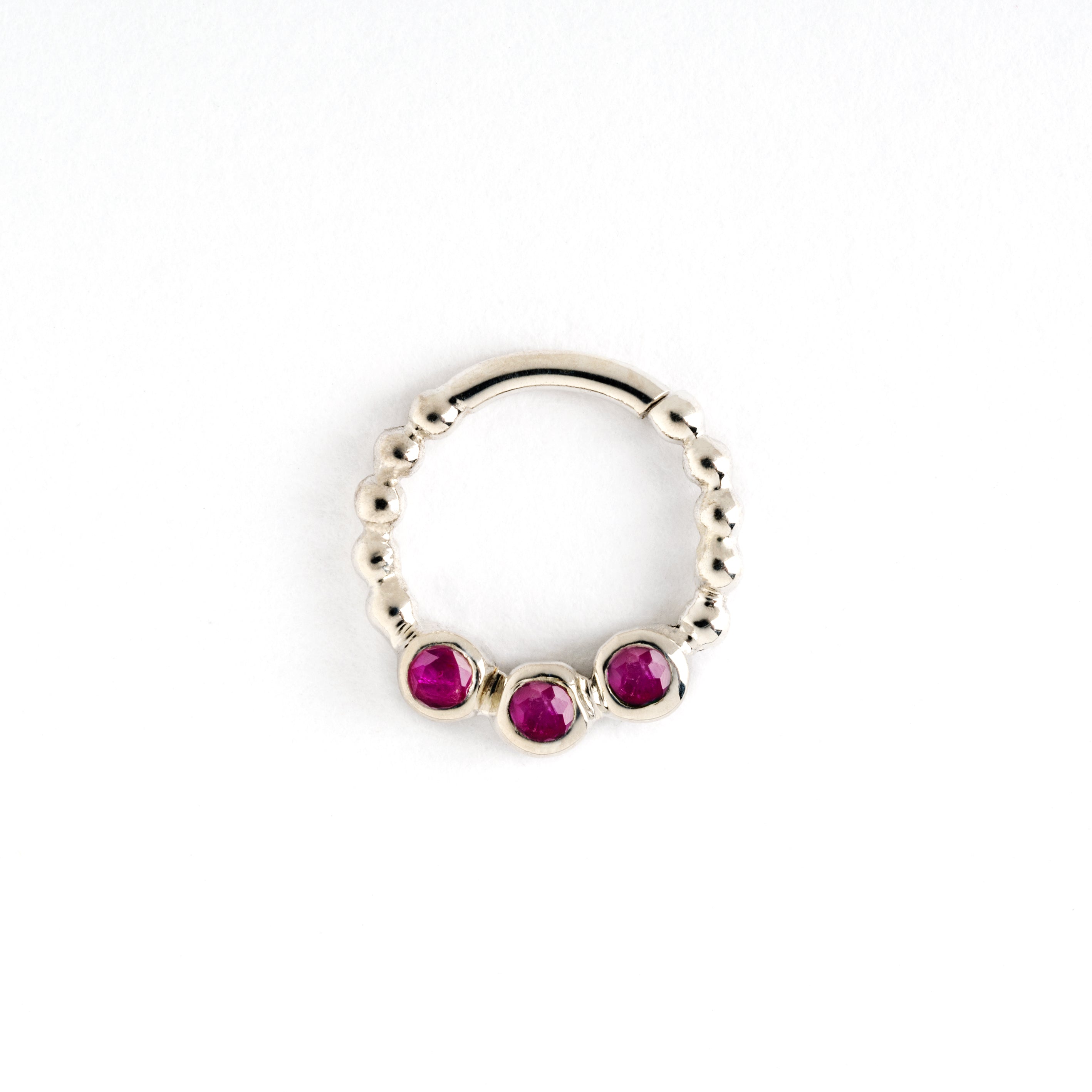 sterling silver dotted septum ring with three ruby gemstones frontal view