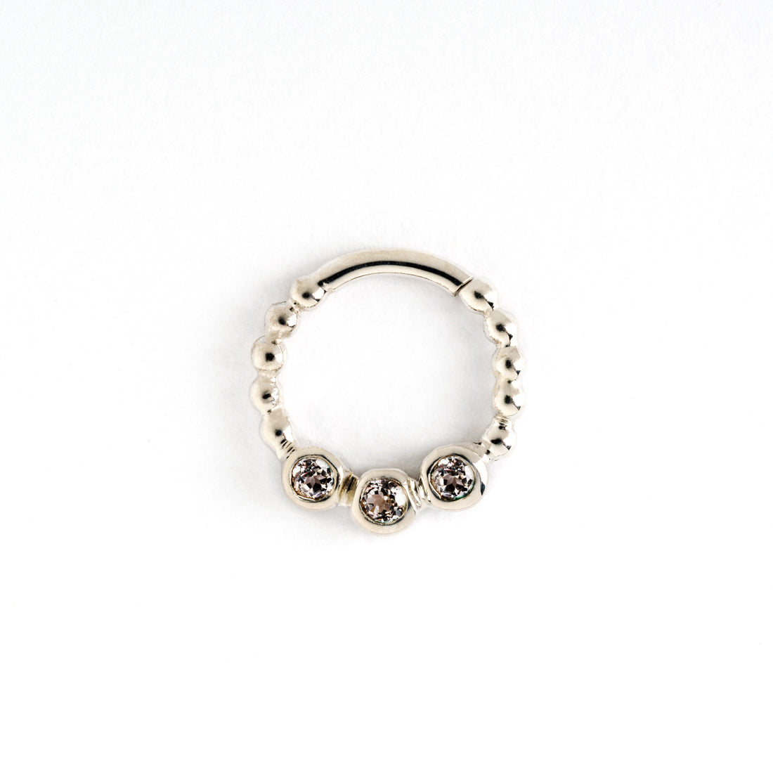 sterling silver dotted septum ring with three white Topaz gemstones frontal view