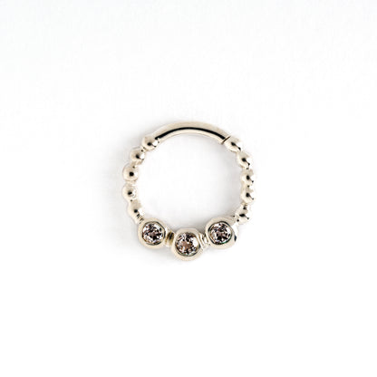 sterling silver dotted septum ring with three white Topaz gemstones frontal view