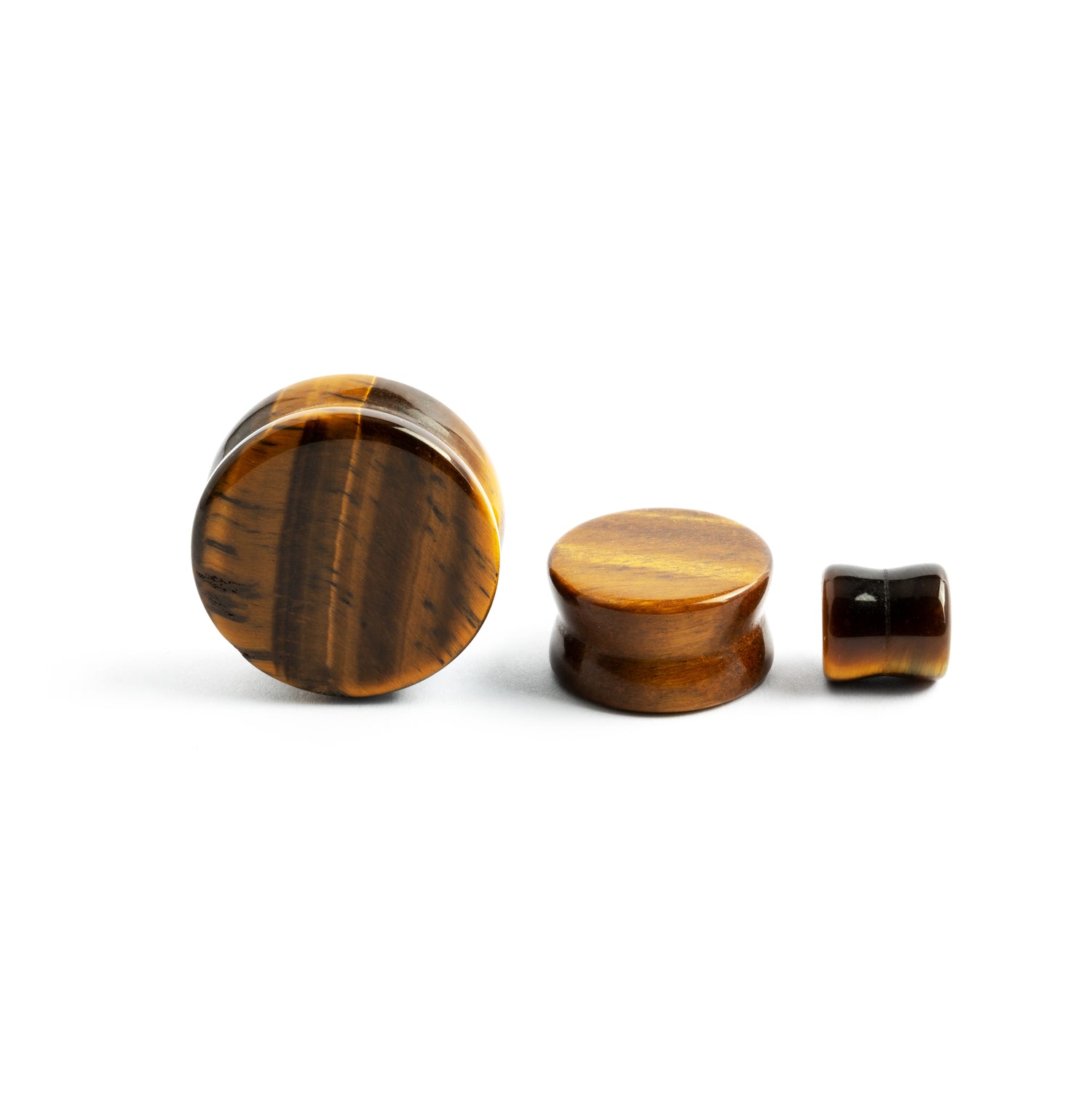 several sizes of tiger eye double flare stone ear plugs front and sideview