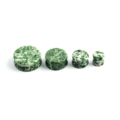 several sizes of double flare Tree Agate sone ear plugs front view