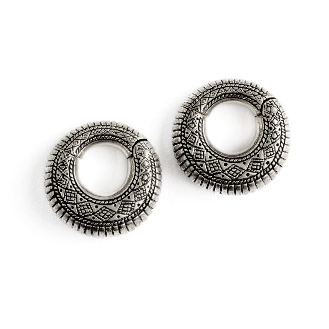 pair of silver brass ear weights hoops with geometric tribal engraved pattern frontal view
