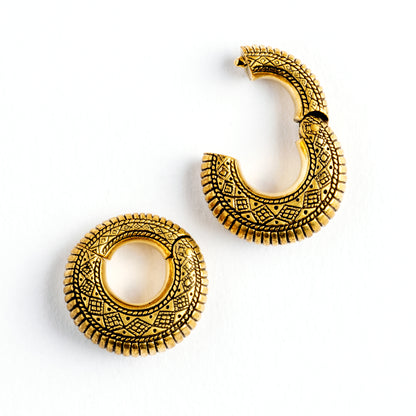 pair of gold brass ear weights hoops with geometric tribal engraved pattern frontal locking system view
