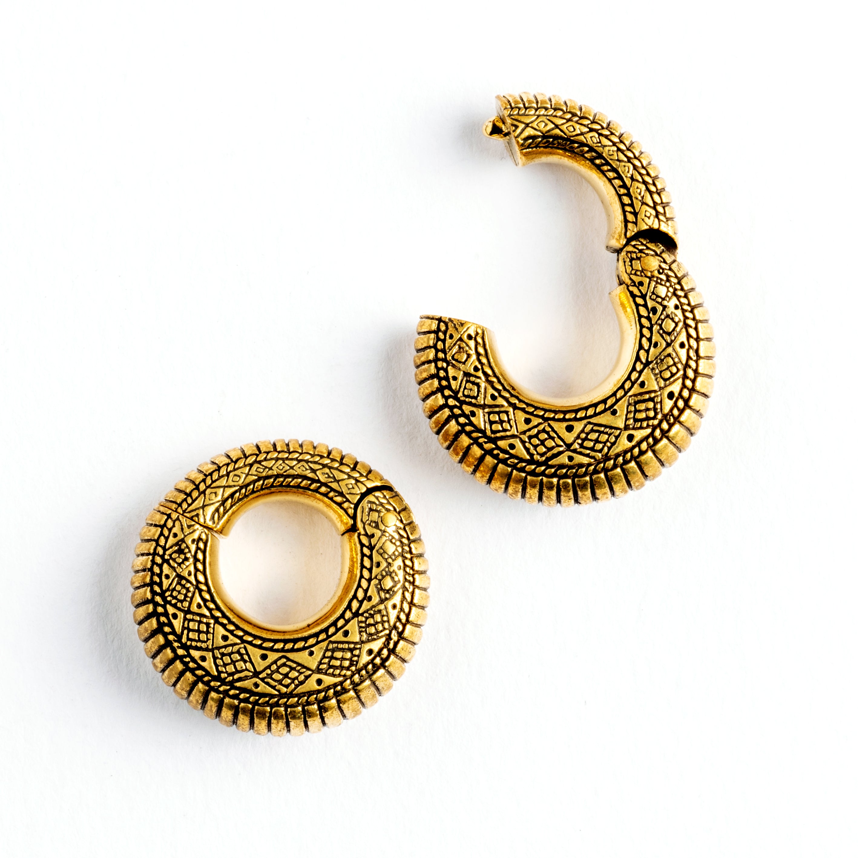 pair of gold brass ear weights hoops with geometric tribal engraved pattern frontal locking system view