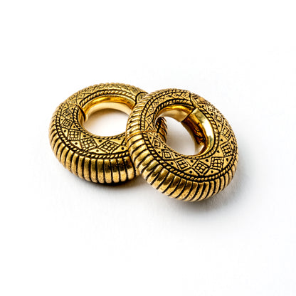 pair of gold brass ear weights hoops with geometric tribal engraved pattern 
