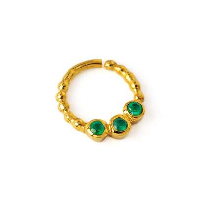gold dotted septum ring with three Emerald gemstones left side view