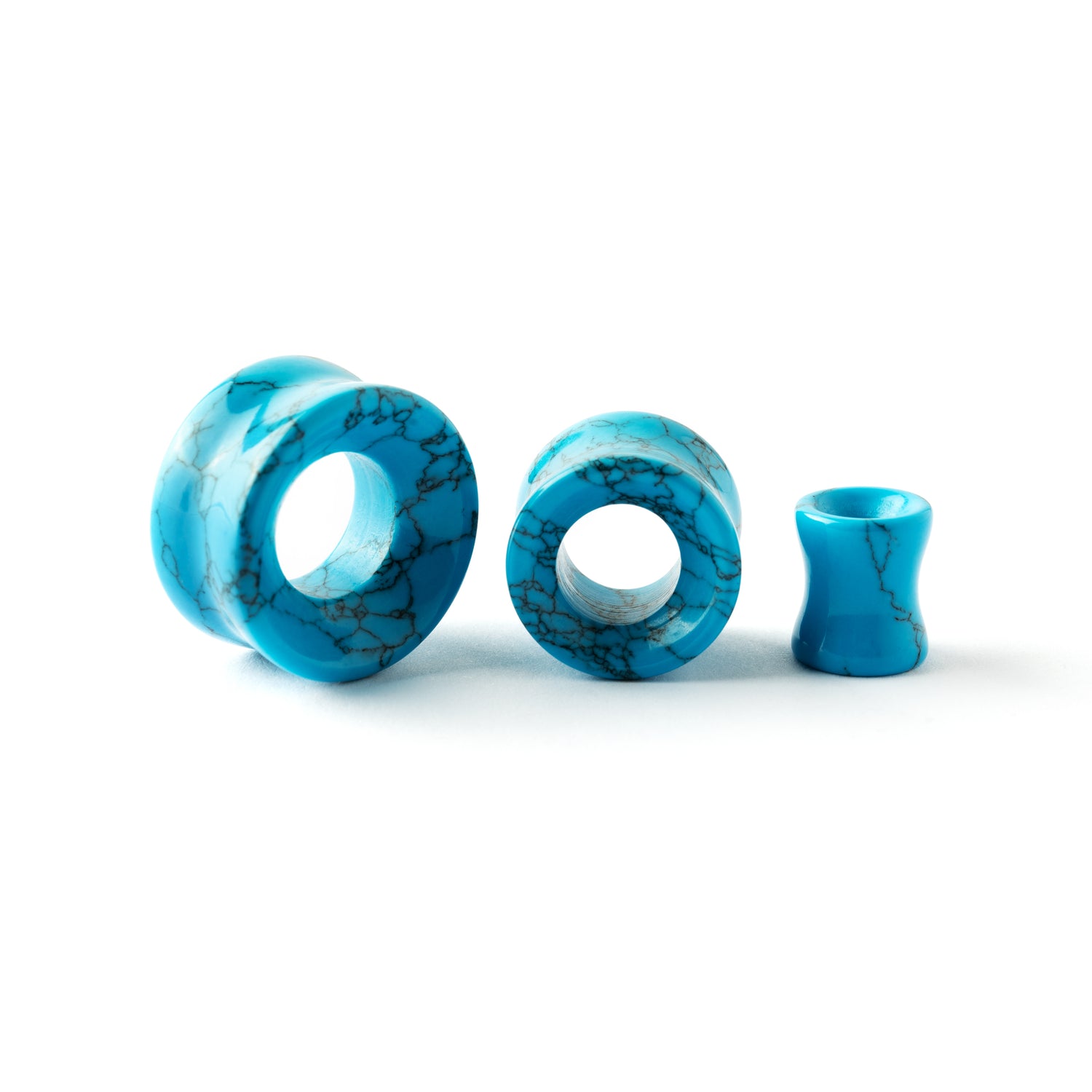 several sizes of turquoise double flare stone ear tunnels front and side view