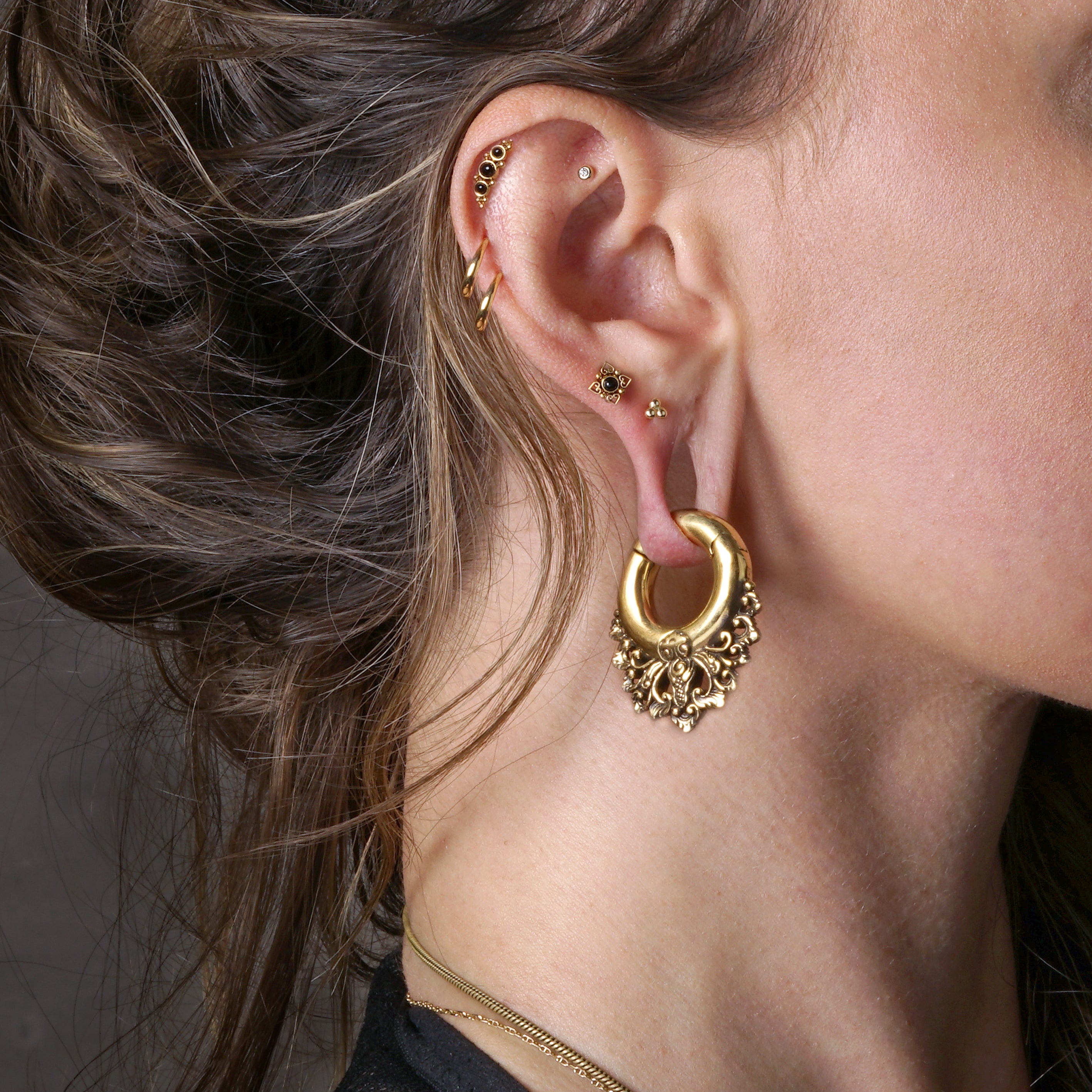 model wearing 14k Gold with CZ internally threaded labret stud on her daith