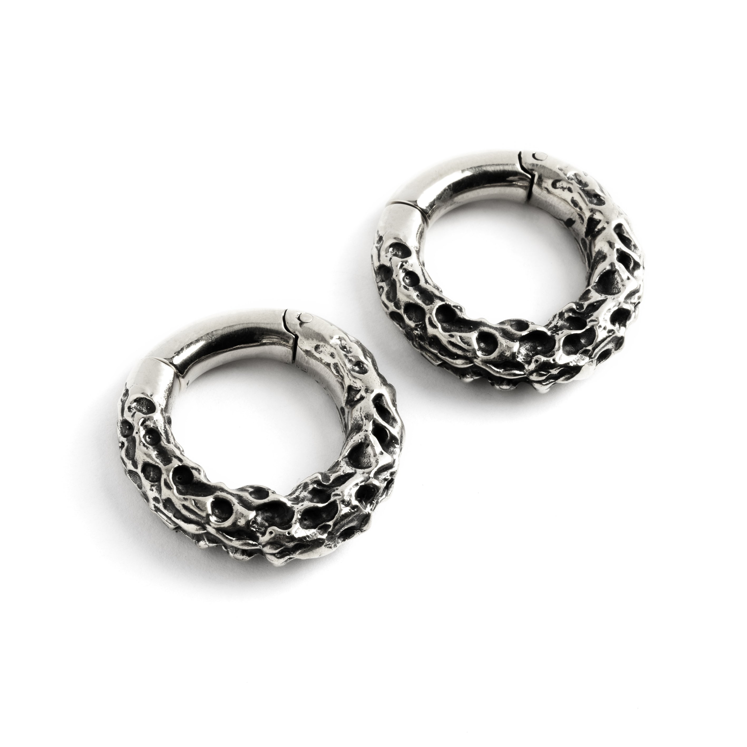 Pair of silver brass hoop hangers with rocky texture left front view