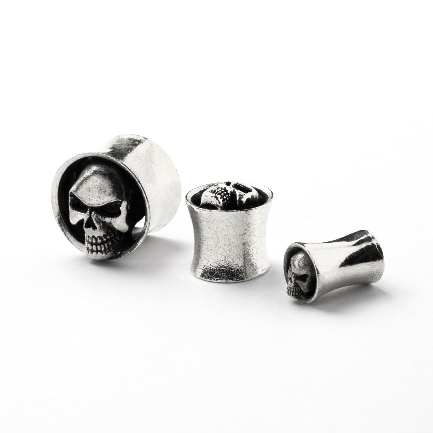 White brass skull ear plugs front and side view
