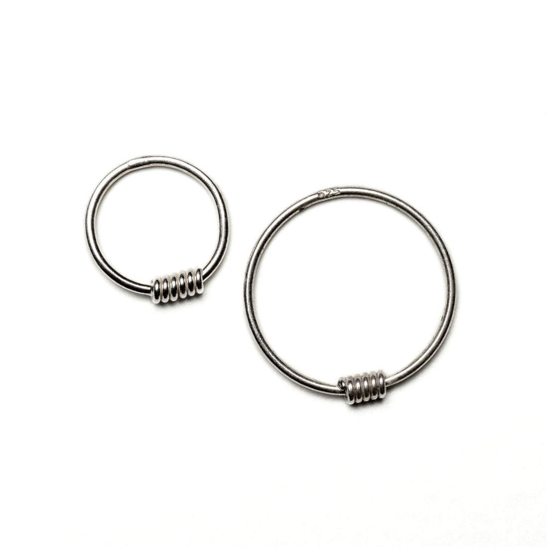 2 sizes of wired silver nose rings frontal view