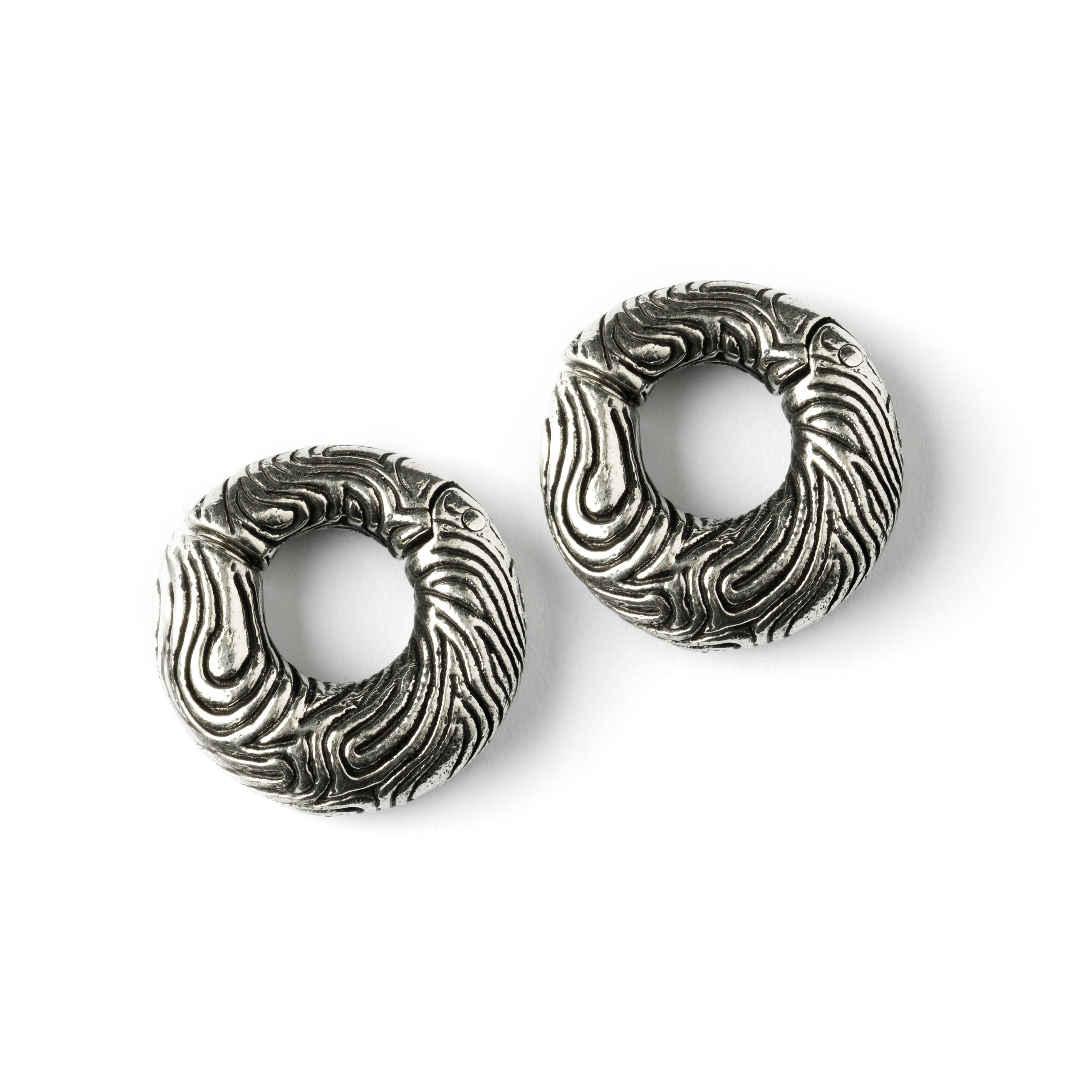 pair of silver brass ear weights hoops with etched curved lines frontal view