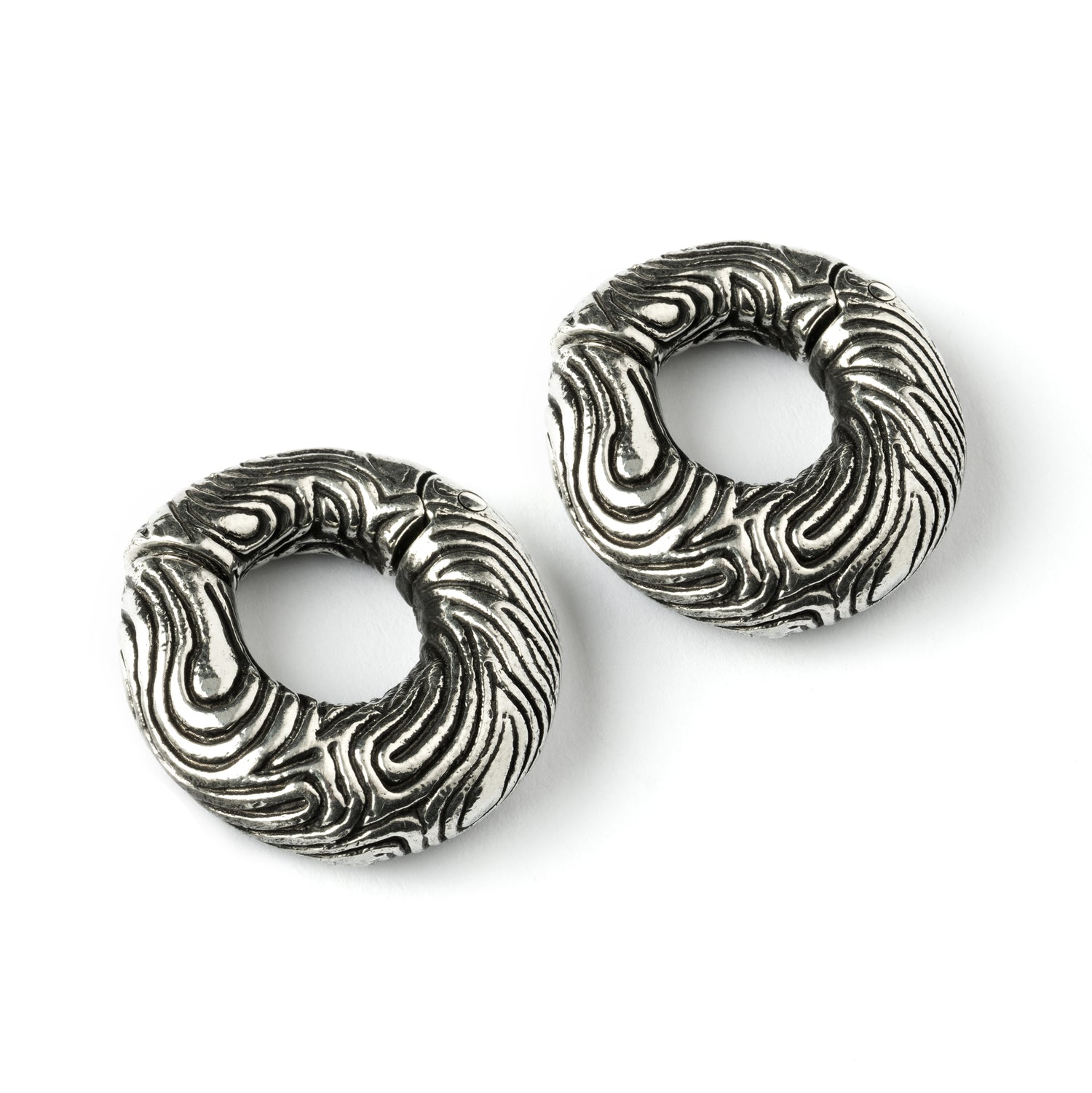pair of silver brass ear weights hoops with etched curved lines front side view