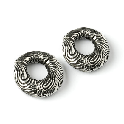 pair of silver brass ear weights hoops with etched curved lines front side view
