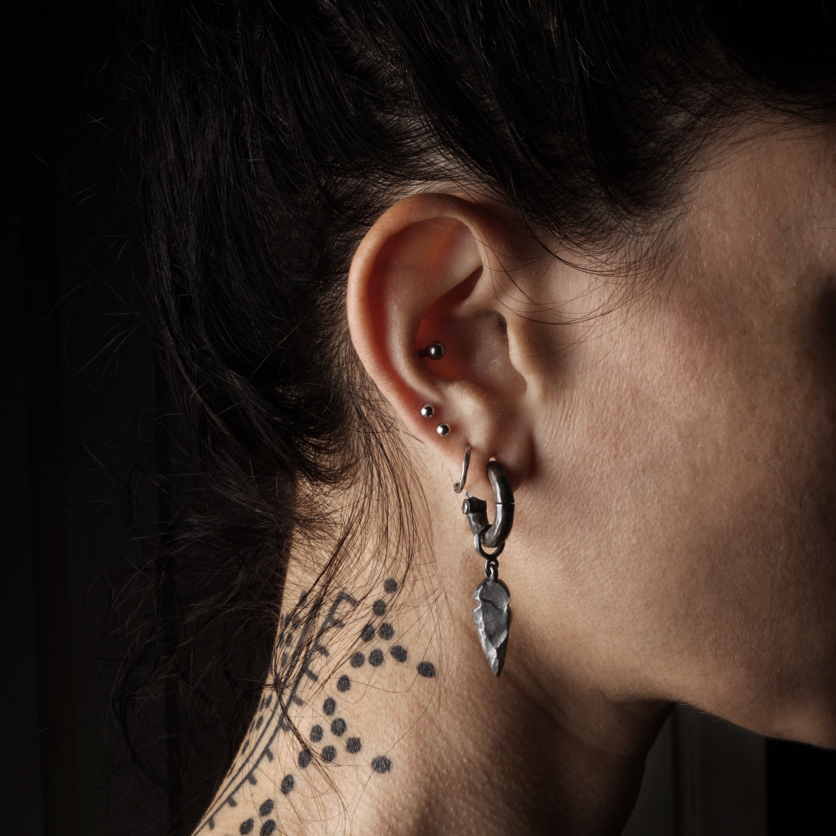 model wearing Black Silver Arrowhead Hangers