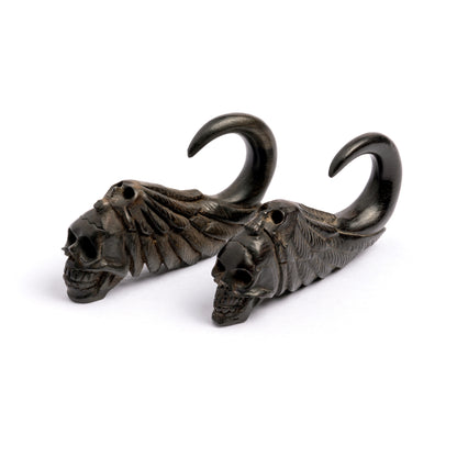 pair of black wood winged skull ear hangers right side and front view