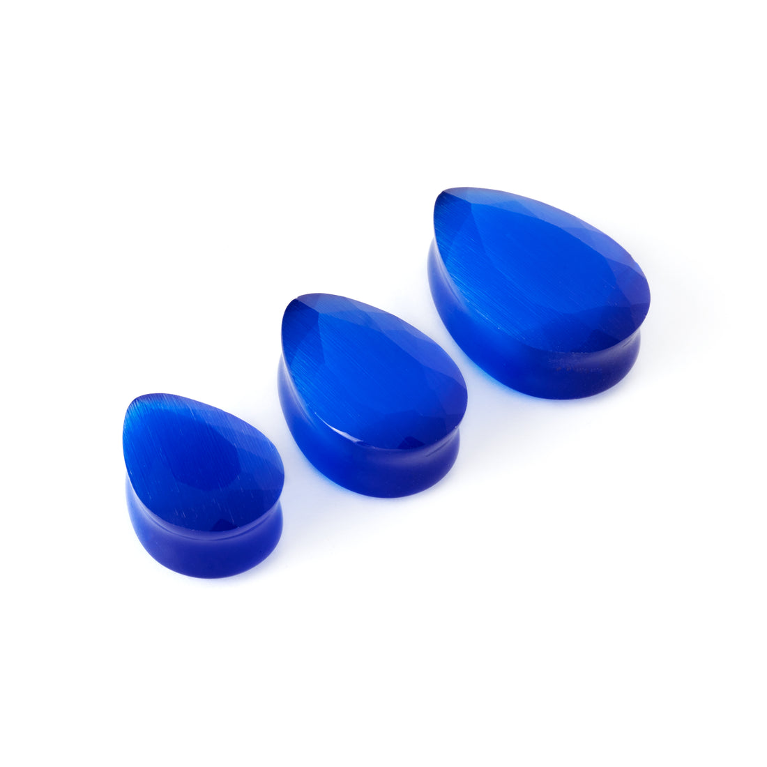 different sizes of blue cat eye teardrop faceted ear plugs side view