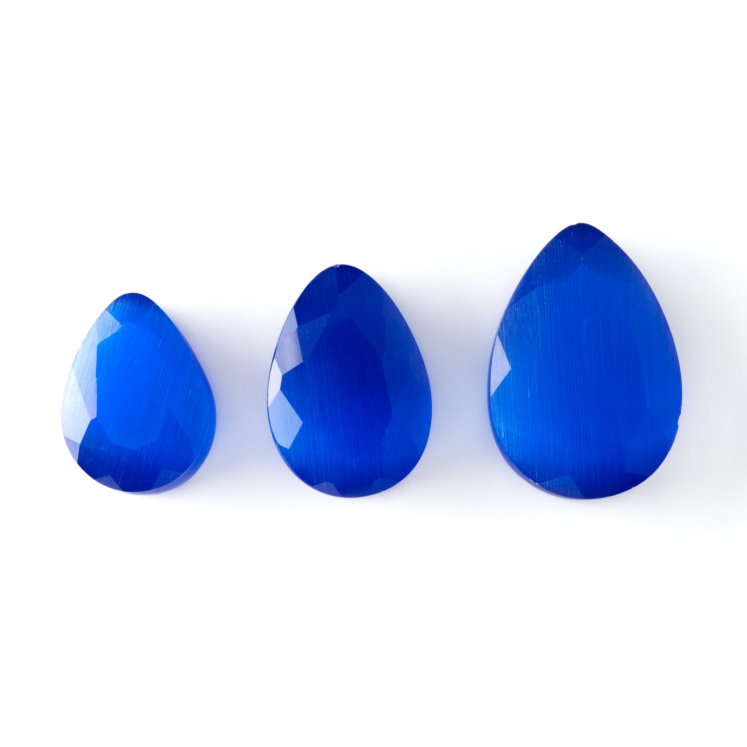 different sizes of blue cat eye teardrop faceted ear plug frontal view