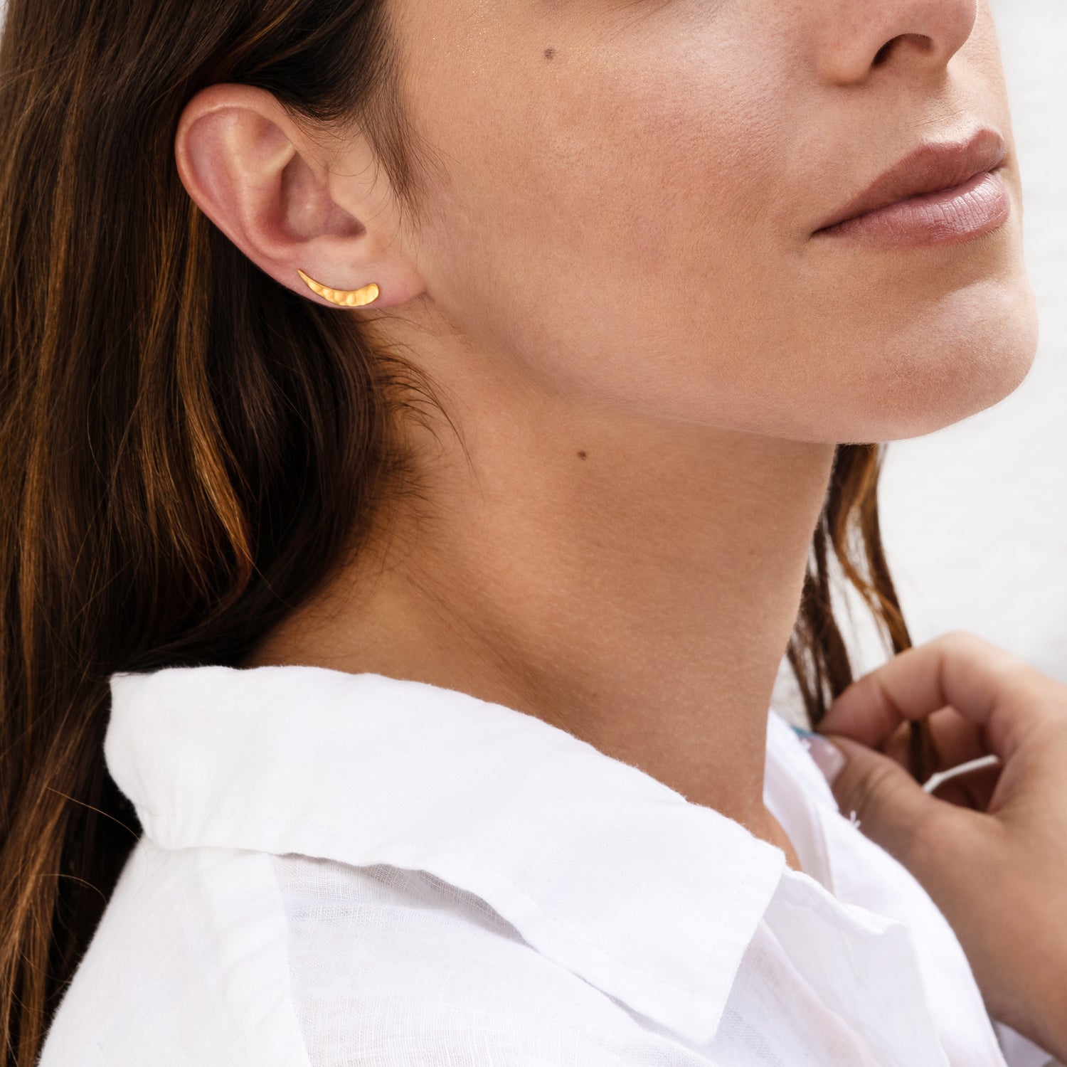 model wearing 24k gold plated silver hammered ear climber close up view