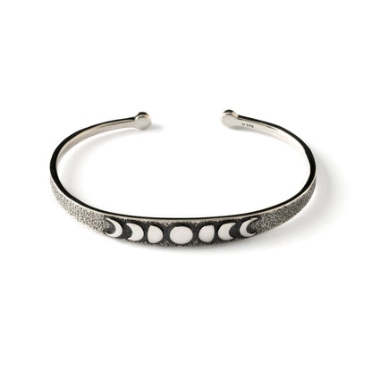 oxidised silver thin open bangle bracelet with embossed moon phases at the front, frontal view