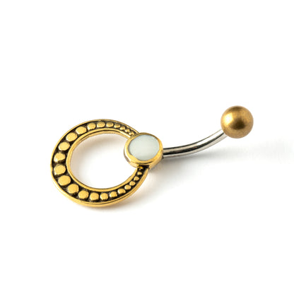 golden brass circle belly piercing with mother of pearl shell side view