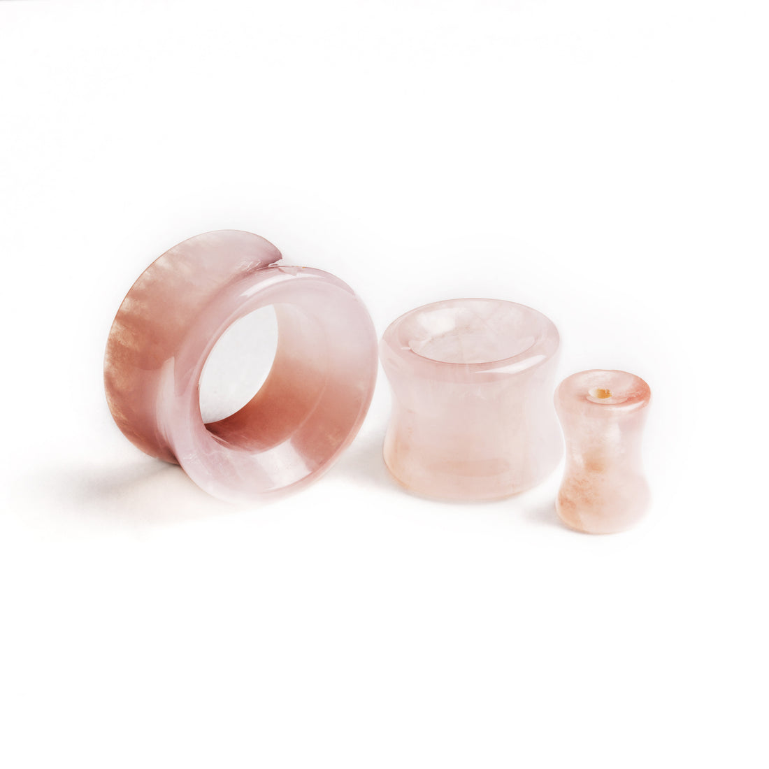 several sizes of rose quartz double flare stone ear tunnels all sides view