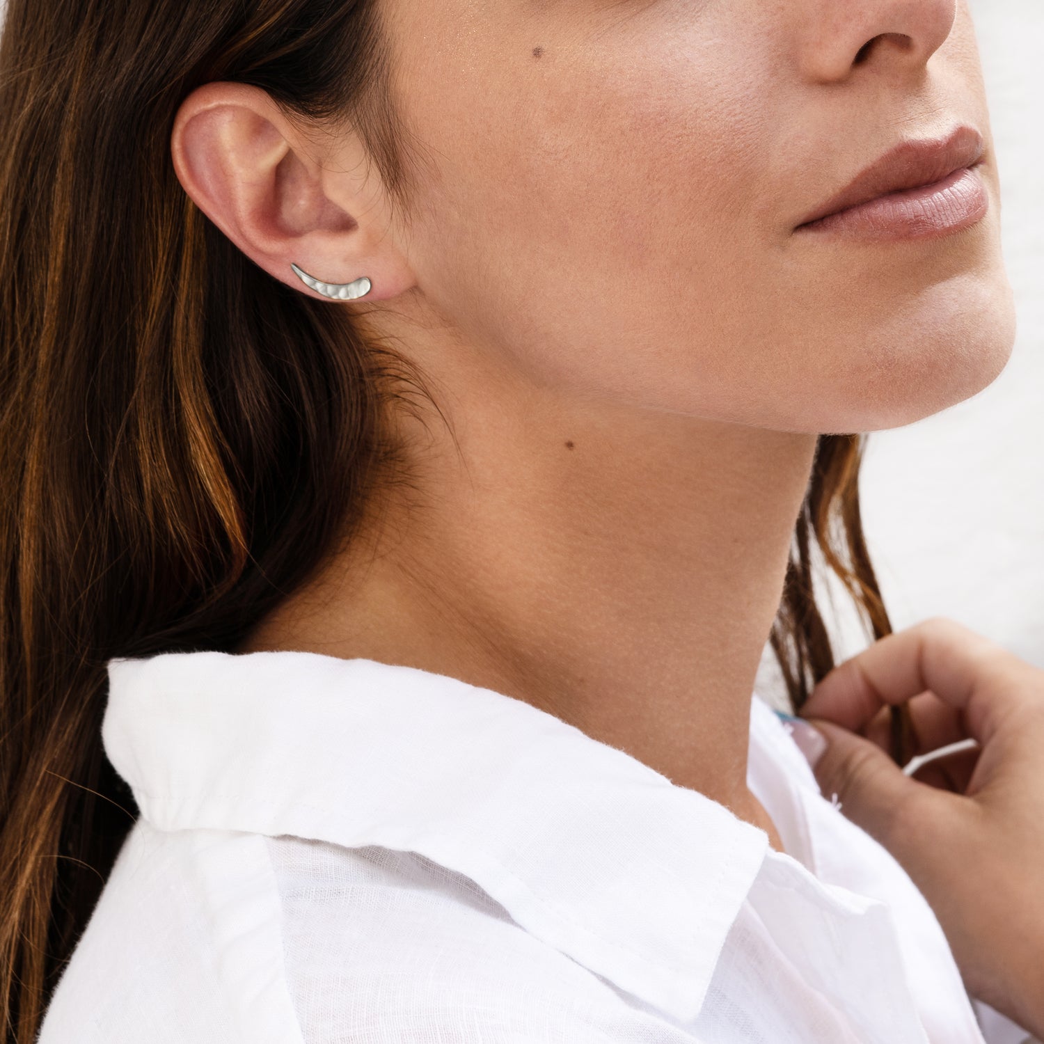 model wearing sterling silver hammered ear climber close up view