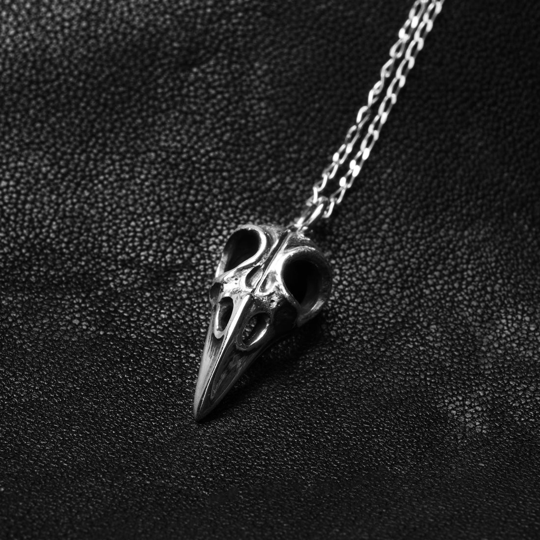 Silver raven skull necklace right side view