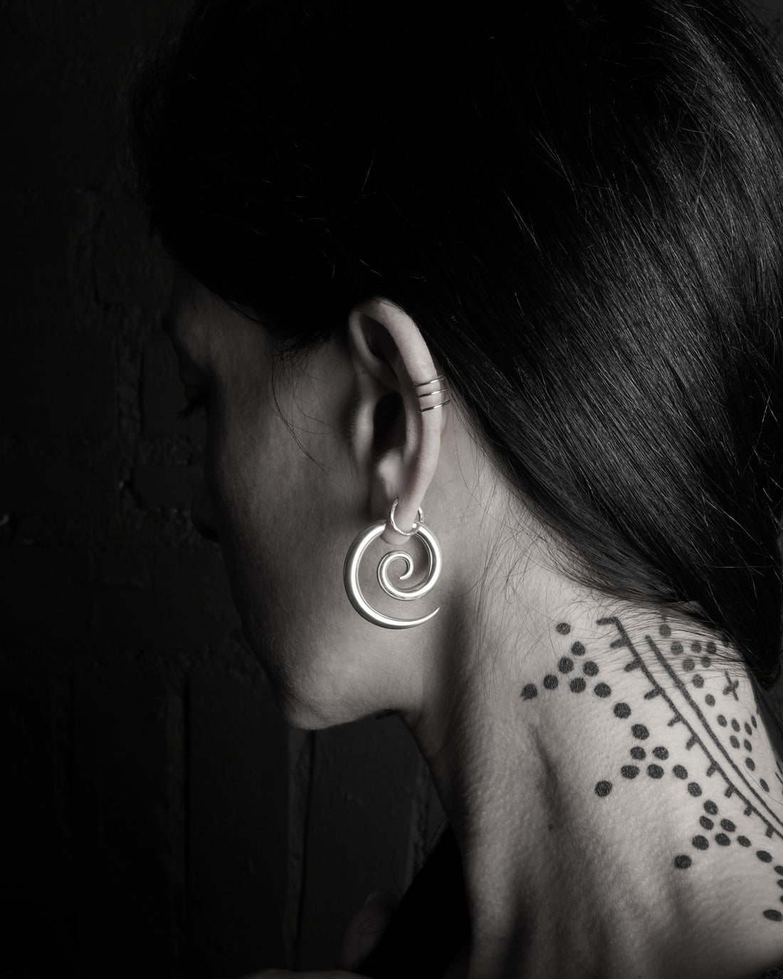 model wearing silver spiral gauge earring